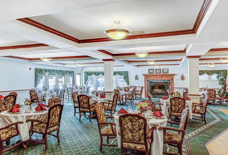 An elegant dining room with ornate chairs and tables set for a meal.