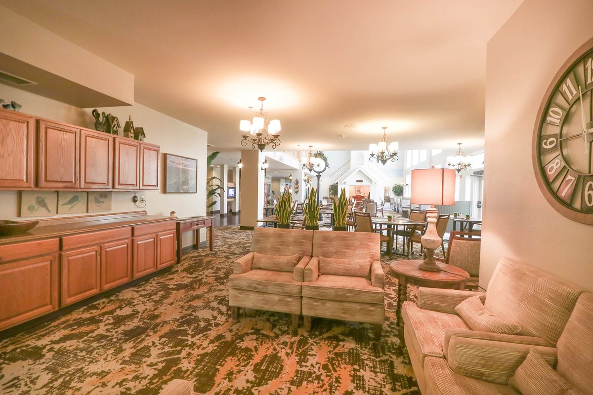 Spacious living and dining area with elegant traditional decor and cozy seating.