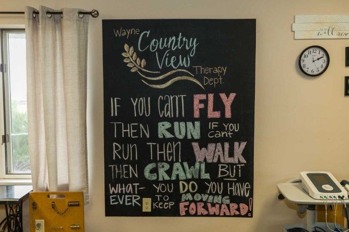 A motivational chalkboard sign encouraging persistence and progress.