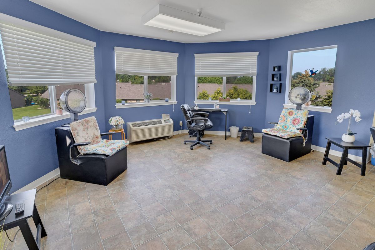 A bright, modern office with large windows and comfortable seating.
