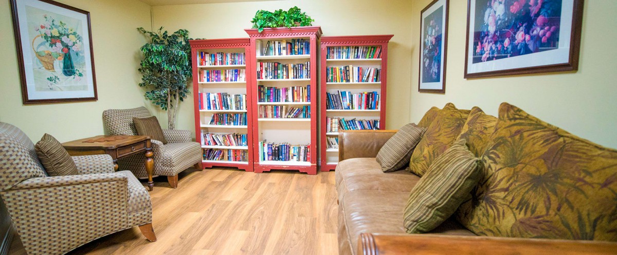 Cozy reading space with bookshelves and a comfortable sofa.