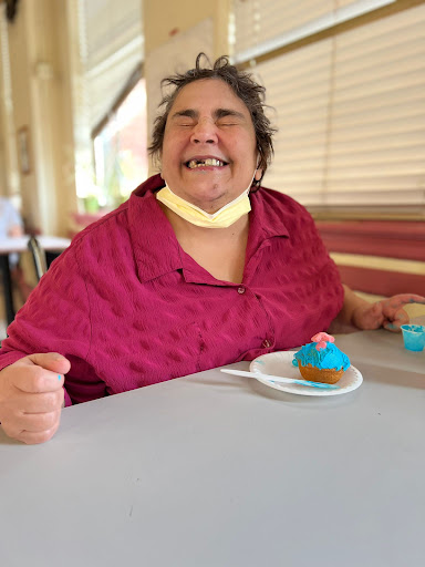 A joyful moment captured as someone enjoys a delicious cupcake.