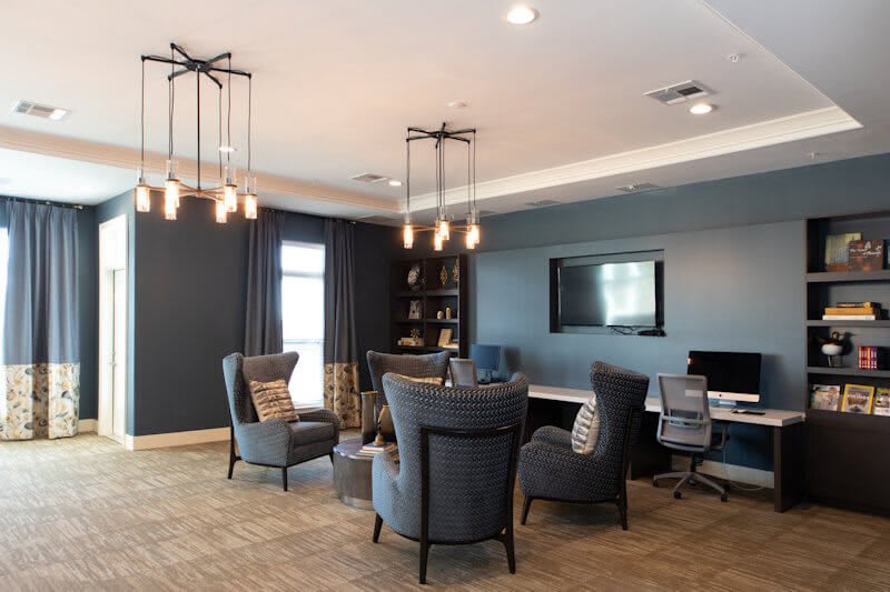 A modern living room with comfortable seating and elegant chandeliers.