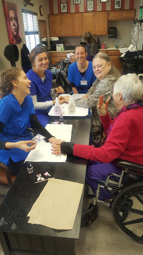 Caregivers and elderly individuals engaging in a joyful activity together.