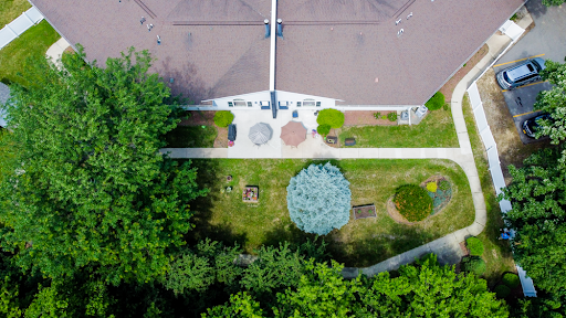 An aerial view of a well-maintained garden featuring various seating arrangements and lush greenery.