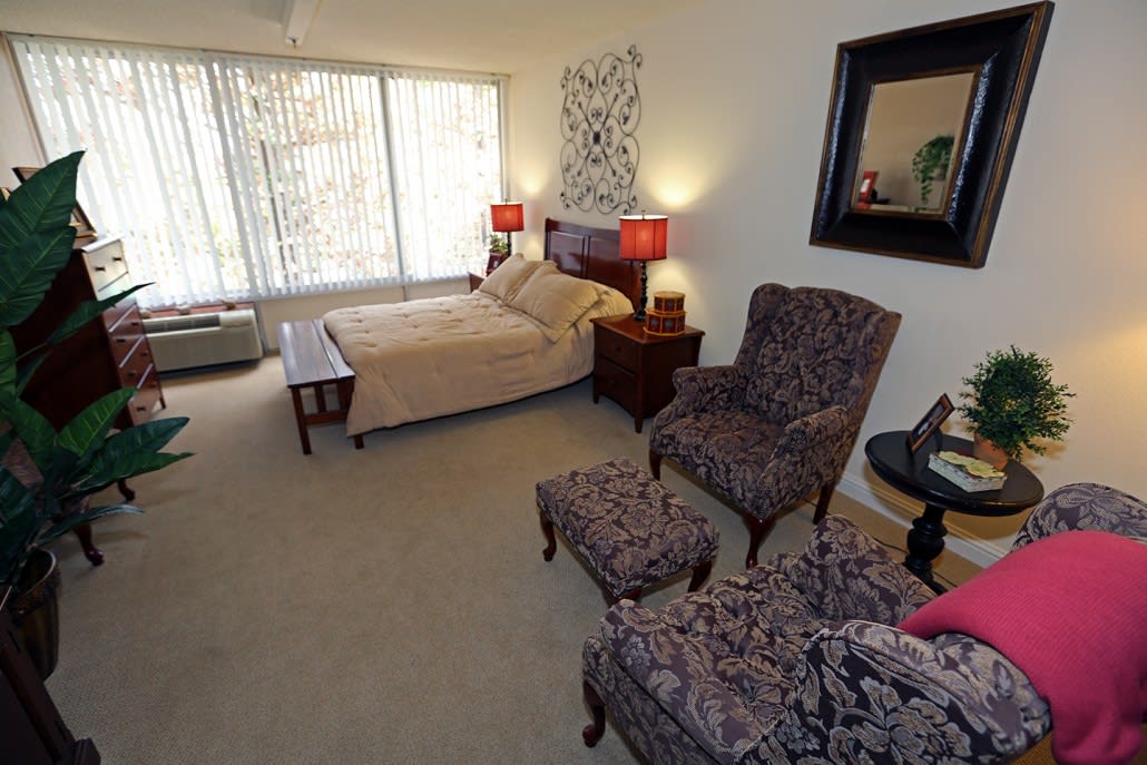 A cozy bedroom with stylish furniture and warm lighting.