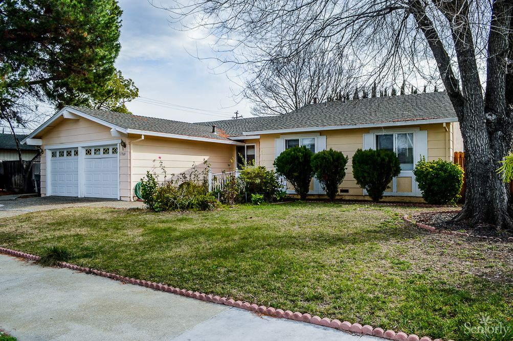 A suburban house with a well-maintained front yard and garage.
