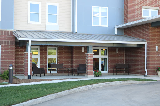 A modern residential building featuring an inviting patio area with seating.