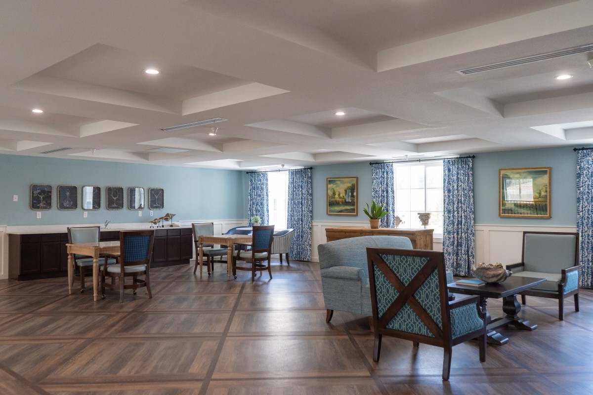 Spacious and elegantly designed living room with comfortable seating and natural lighting.