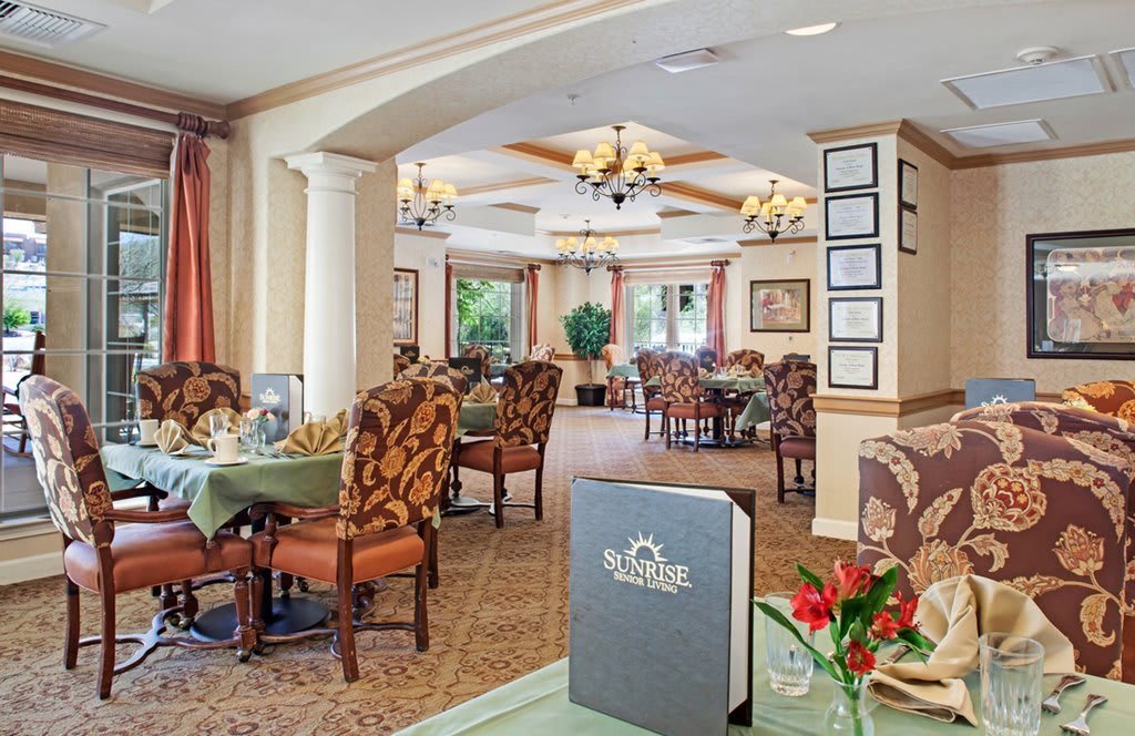 An elegant restaurant dining room with neatly arranged tables and chairs.