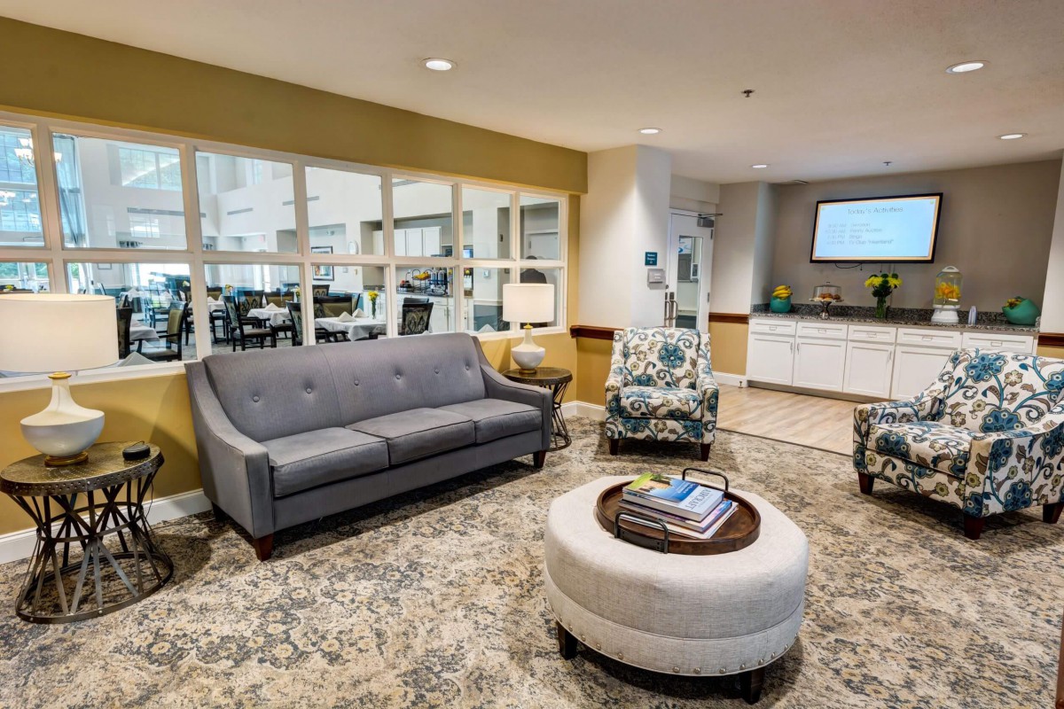 A modern living room with a grey sofa, coffee table, and stylish decor.