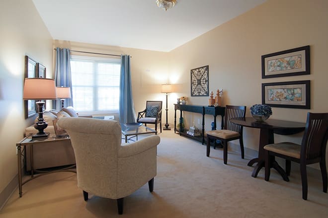 A cozy living room with comfortable seating, soft lighting, and stylish decor.