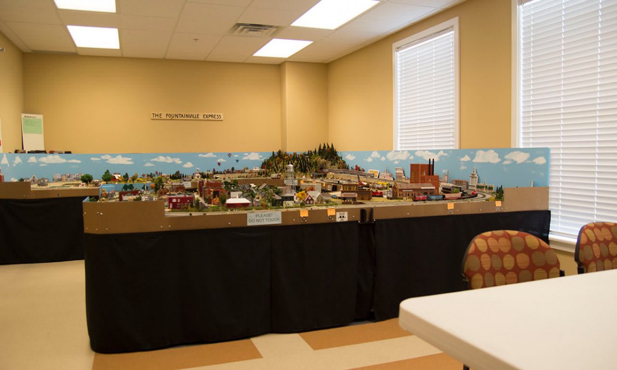 A detailed model train layout displayed in an indoor setting.