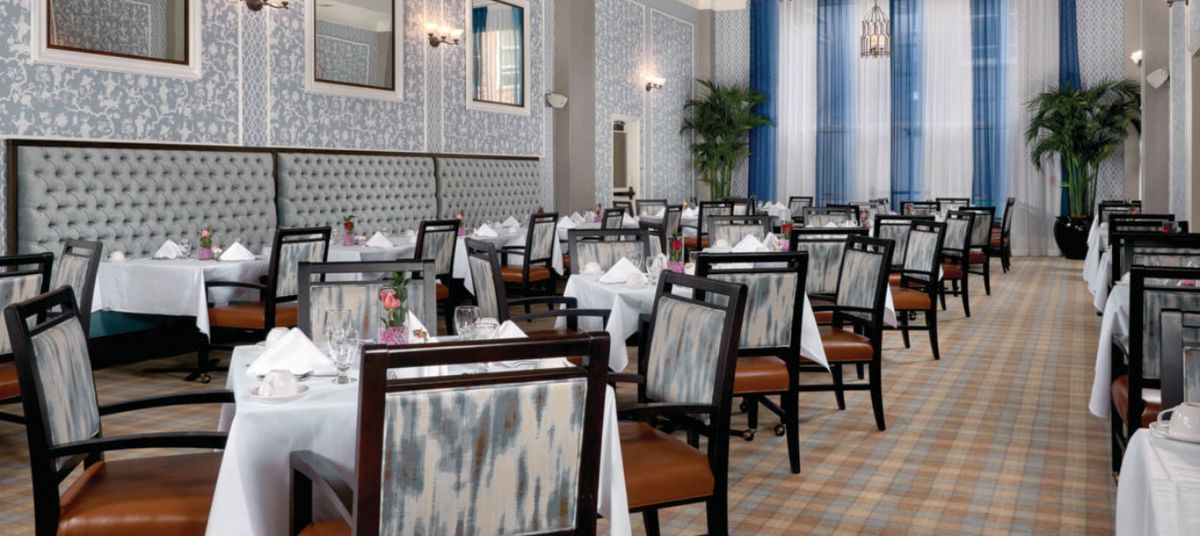 An elegant restaurant dining area with neatly set tables and chairs.