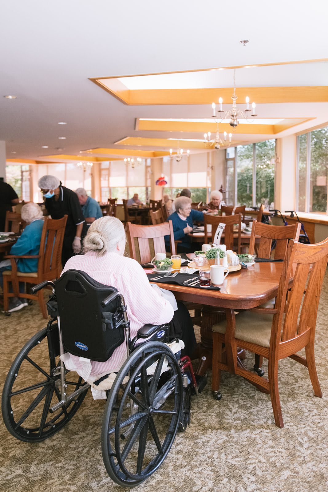 Elderly residents dining together in a senior living facility.