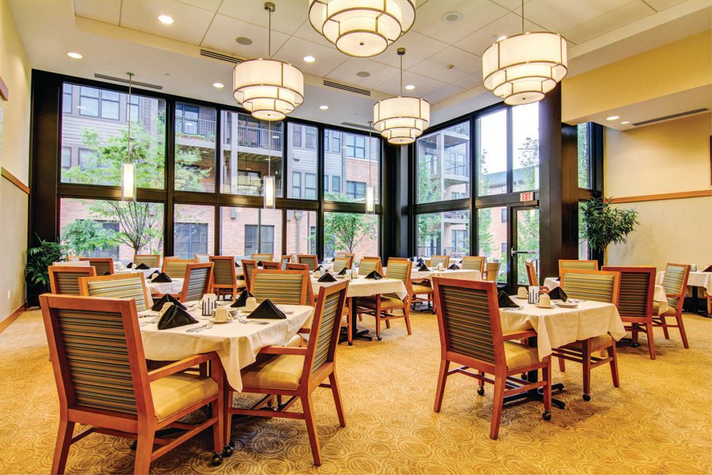 An elegant restaurant dining area with large windows and stylish lighting.