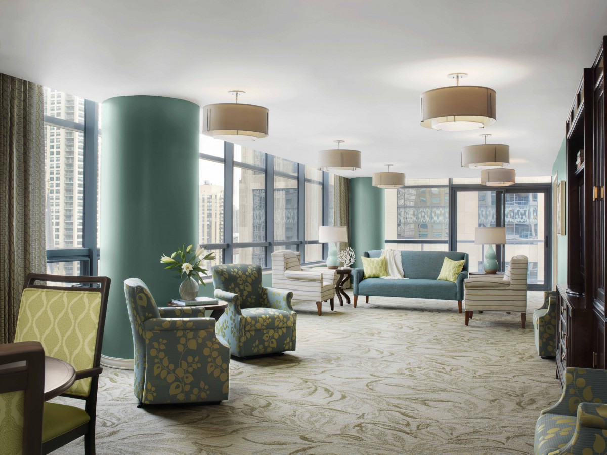 A modern lounge area with comfortable seating and large windows.