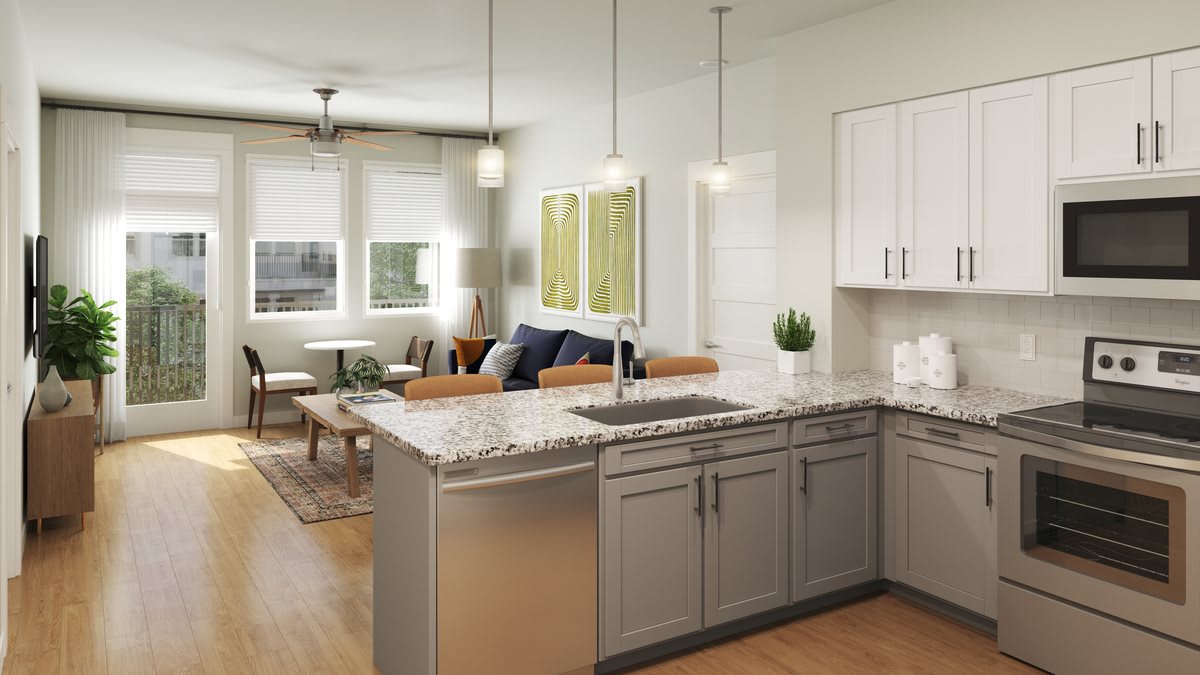 Modern open-concept kitchen and living area with a stylish kitchen island and pendant lighting.