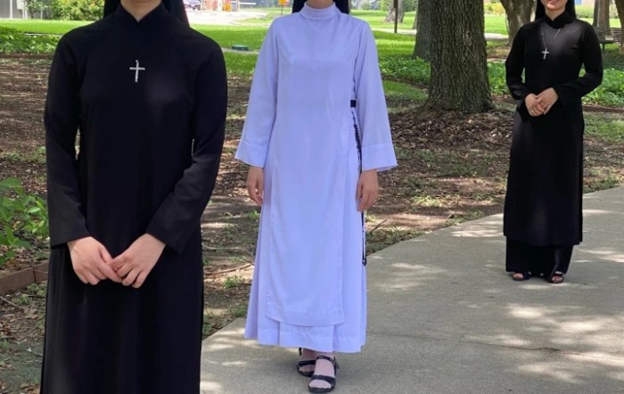 A group of individuals in religious attire walking outdoors.