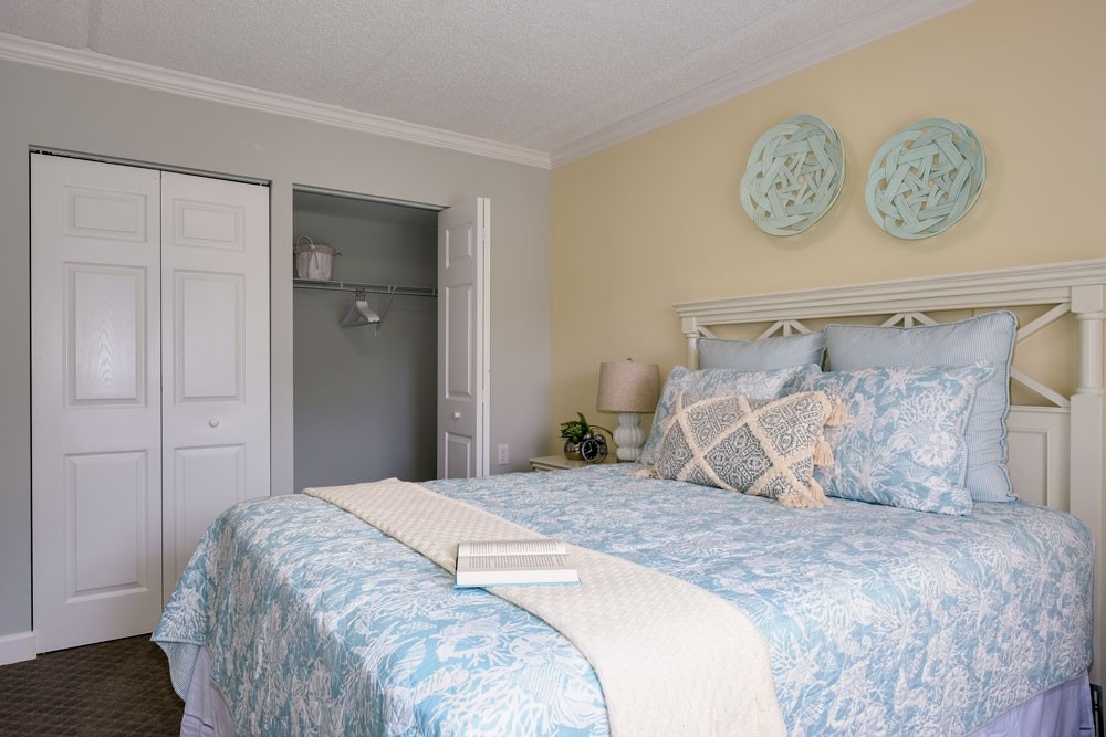 A cozy bedroom with soft, neutral-colored decor and a neatly made bed.