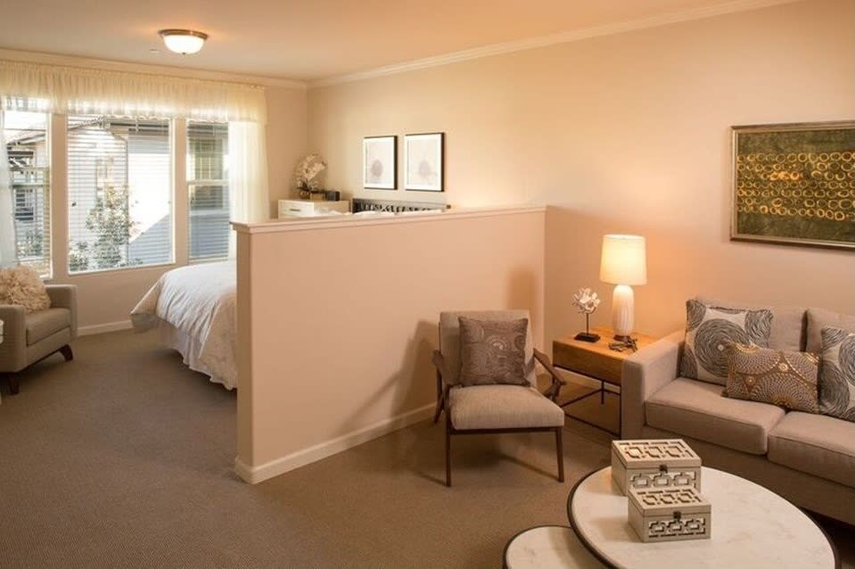A cozy open-plan living area with a separate bedroom section.