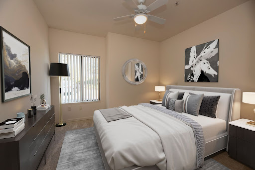 A beautifully designed modern bedroom featuring neutral tones and stylish furnishings.