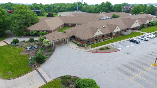 An aerial view of a well-maintained residential community surrounded by lush greenery.