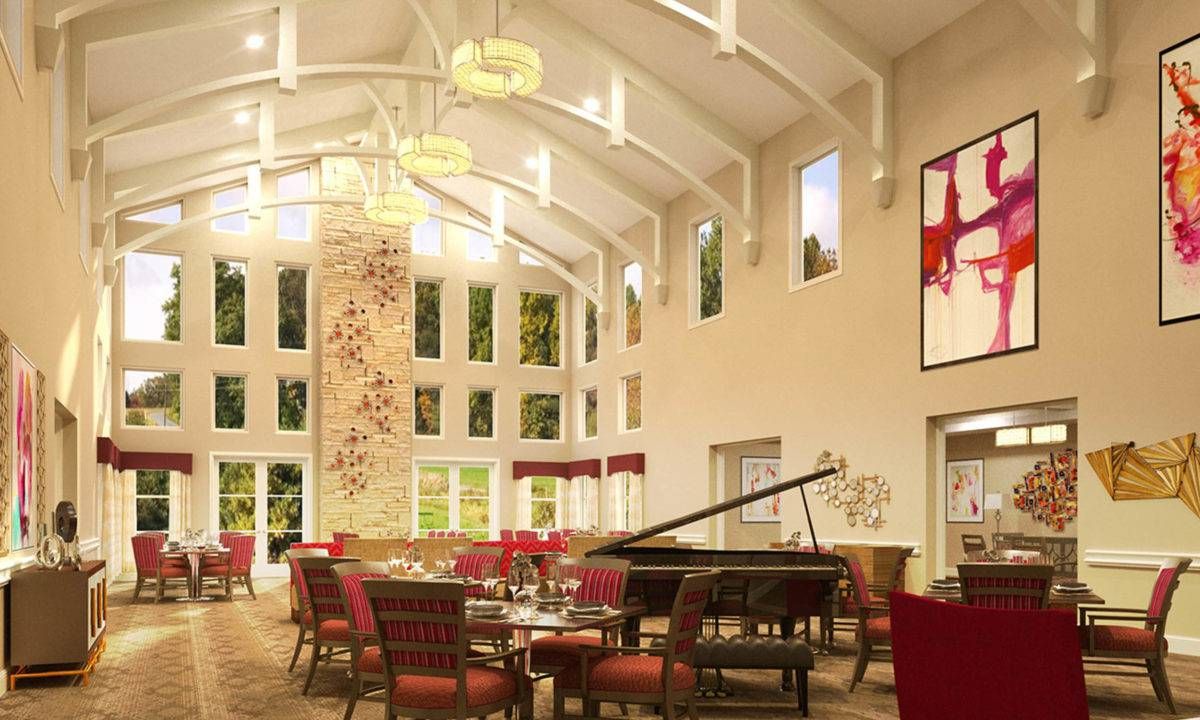 A spacious and elegantly designed interior featuring a grand piano, high ceilings, and decorative chandeliers.