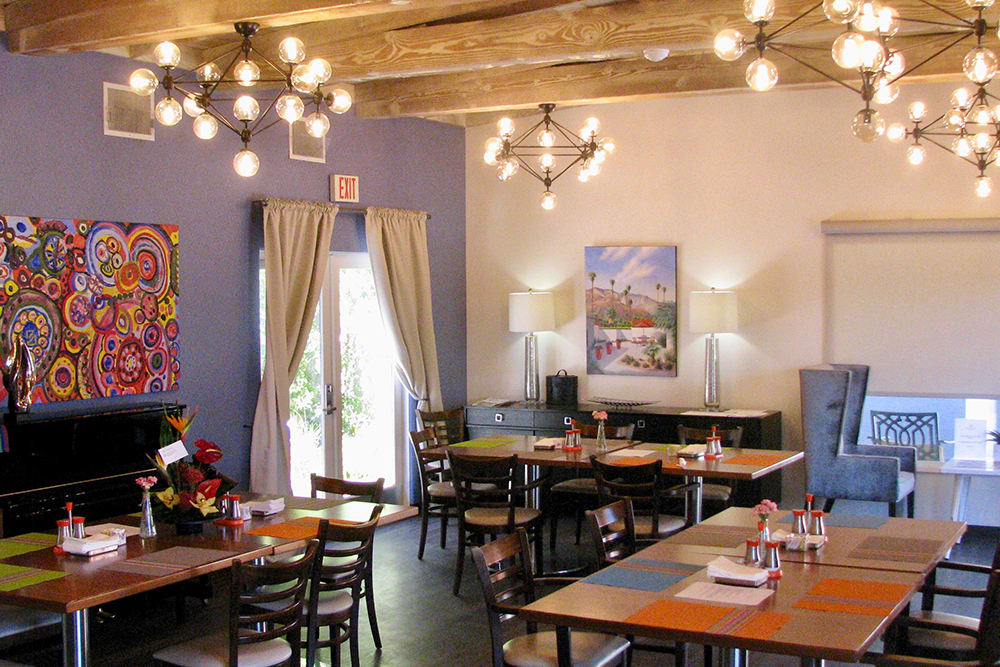 A cozy restaurant interior with wooden tables and modern lighting.