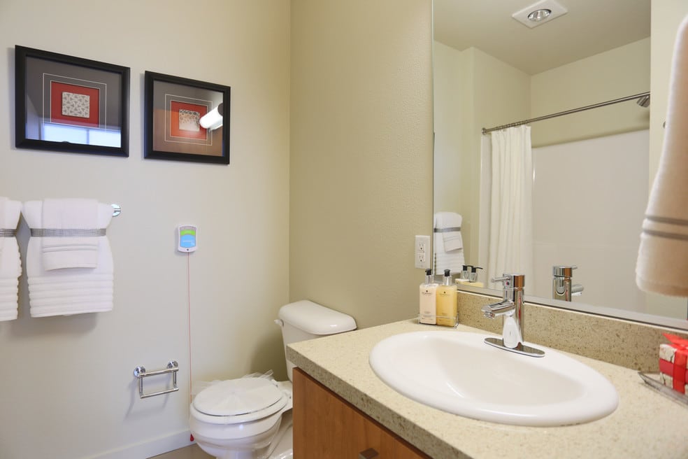Modern bathroom with a sink, mirror, and shower area.
