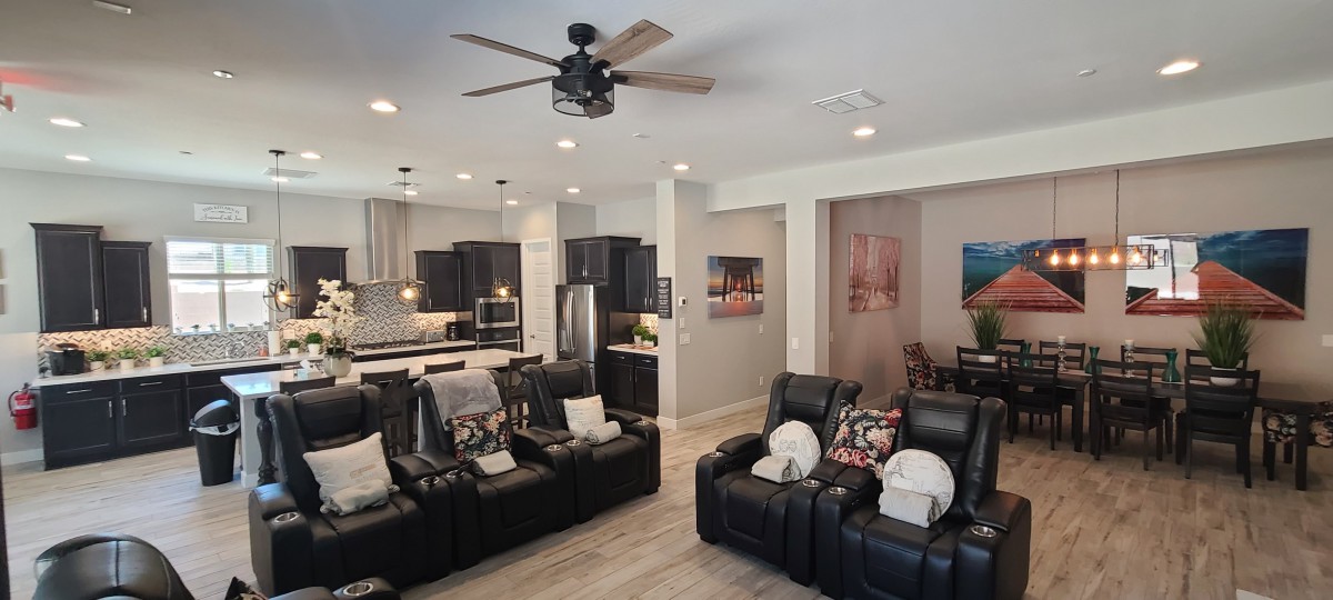 Open-concept living space with a modern kitchen and home theater seating.