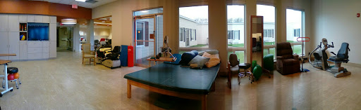 A cozy lobby area with a large sofa and natural light coming through the windows.