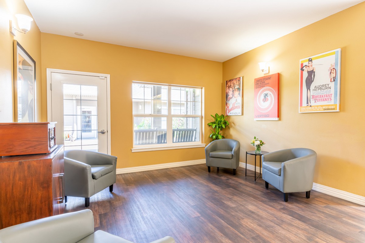 A modern waiting room featuring comfortable seating and natural lighting.