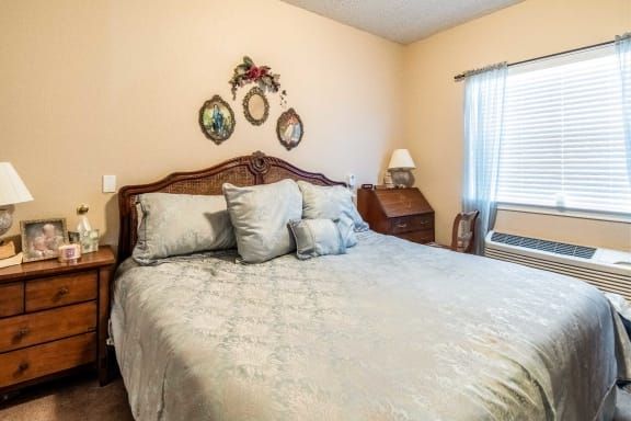A cozy bedroom with a vintage-style bed and wall decorations.