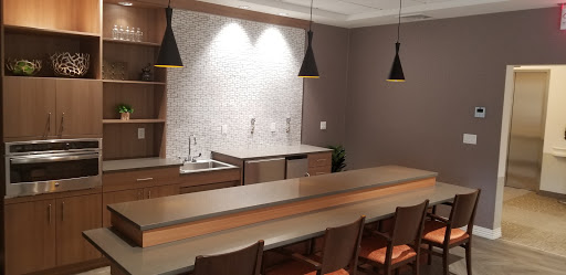 A sleek and modern kitchen bar area featuring stylish lighting and contemporary design elements.