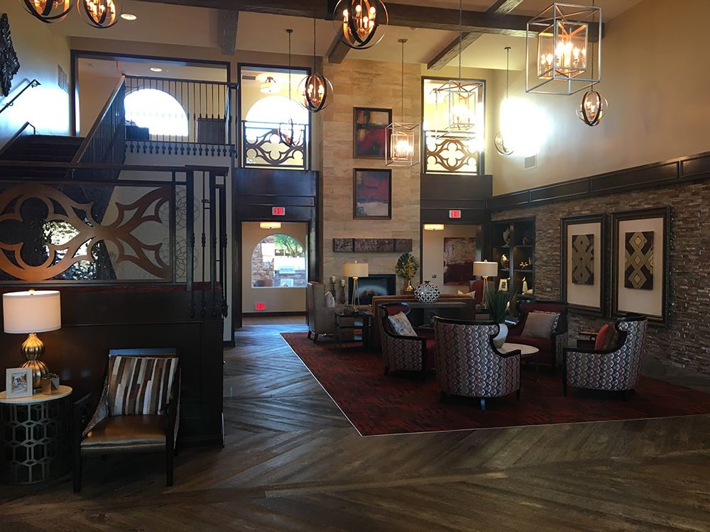 A spacious and elegantly designed lobby featuring comfortable seating areas and stylish lighting fixtures.