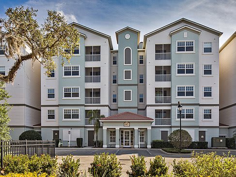 A modern multi-story apartment complex with a symmetrical design.