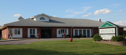 A well-maintained brick building with a spacious lawn and clear blue skies.