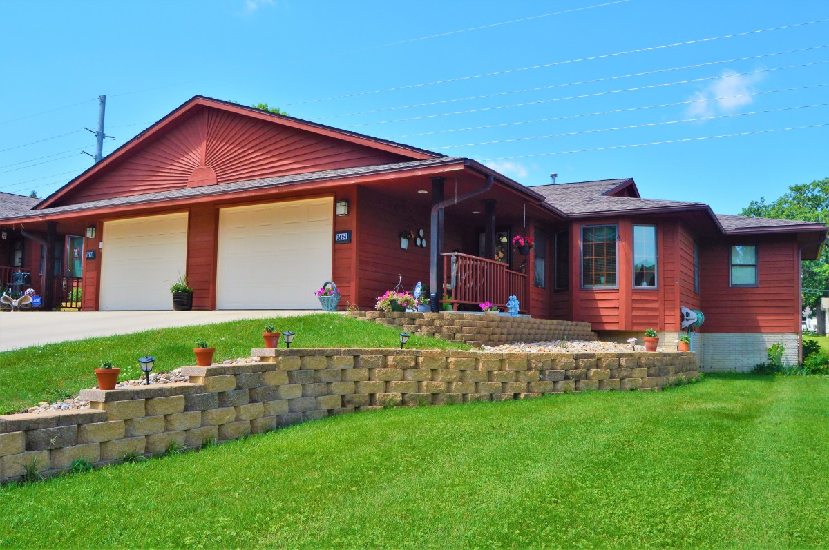 A suburban house with a well-maintained lawn and a two-car garage.