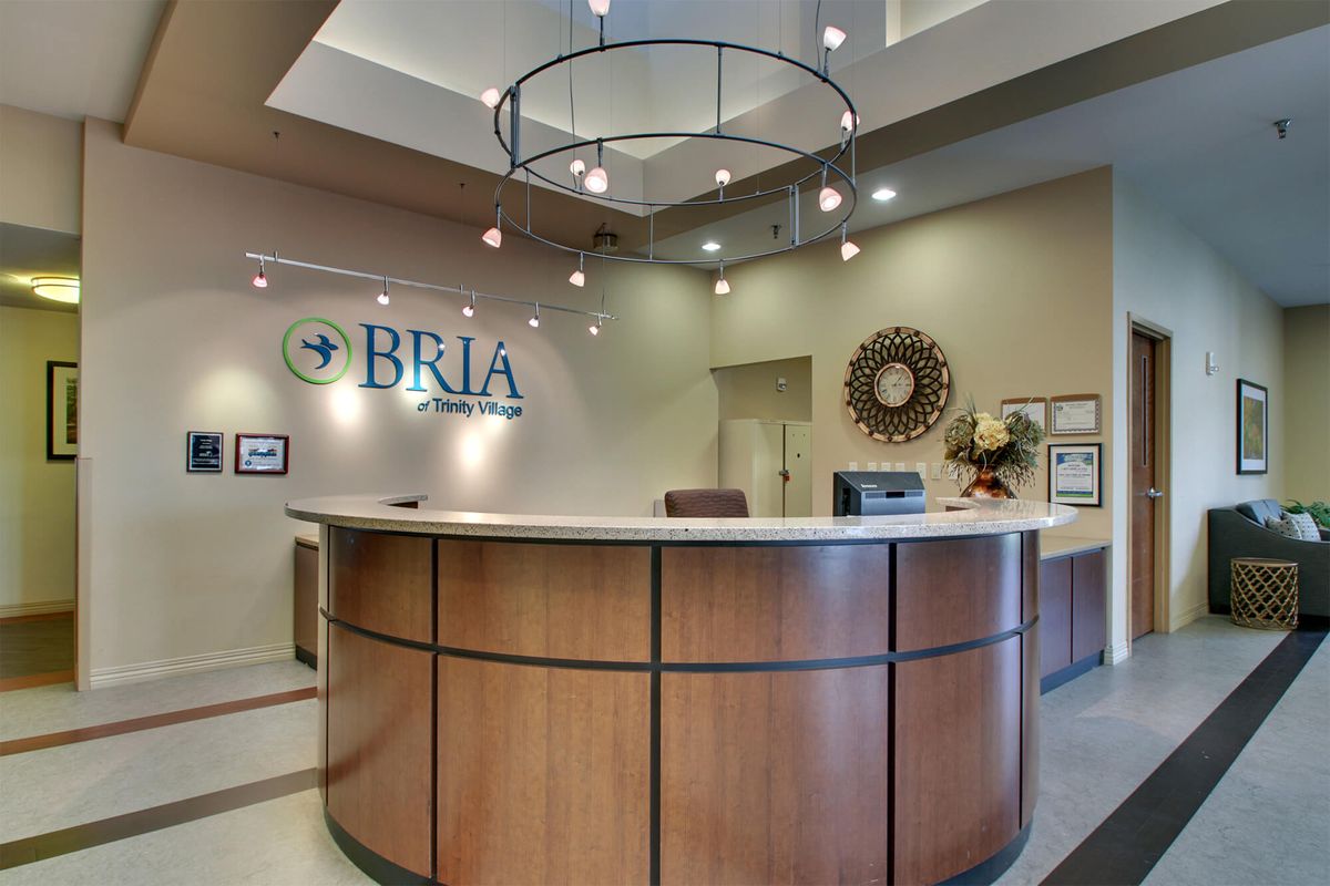 A modern office reception area with a curved desk and stylish decor.