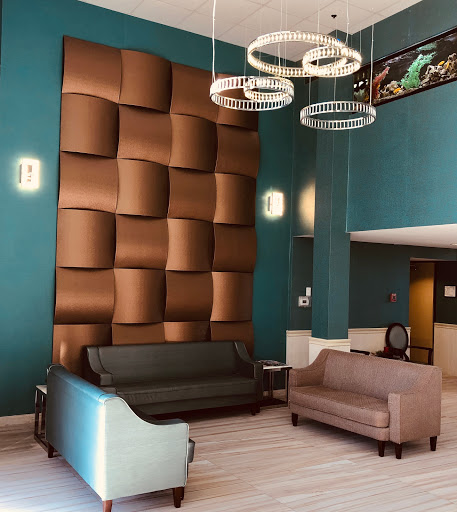 A stylish and modern lobby featuring unique wall design and contemporary furniture.