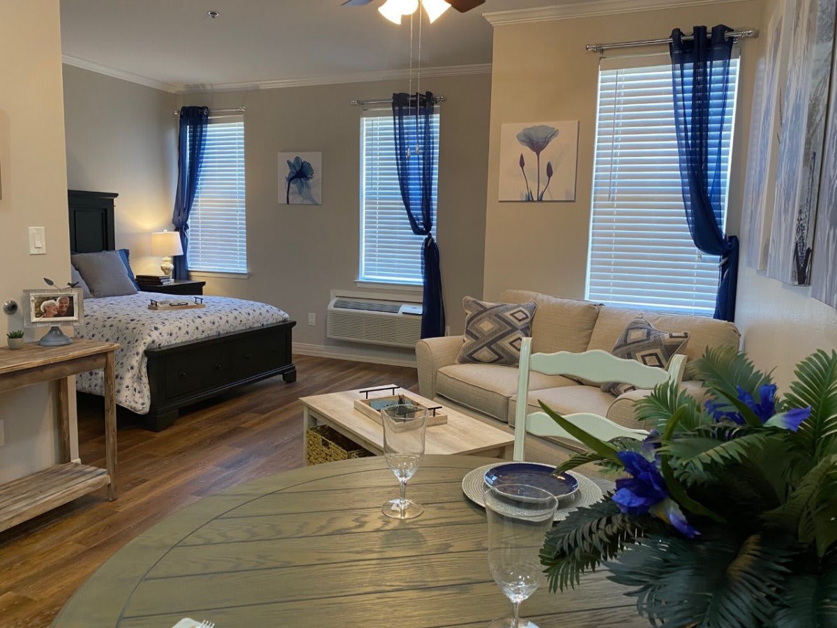 A cozy, modern studio apartment with stylish blue accents and comfortable furnishings.