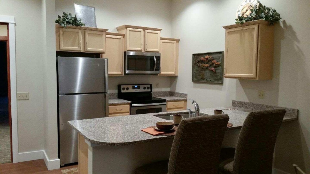 Modern kitchen with stainless steel appliances and sleek cabinetry.