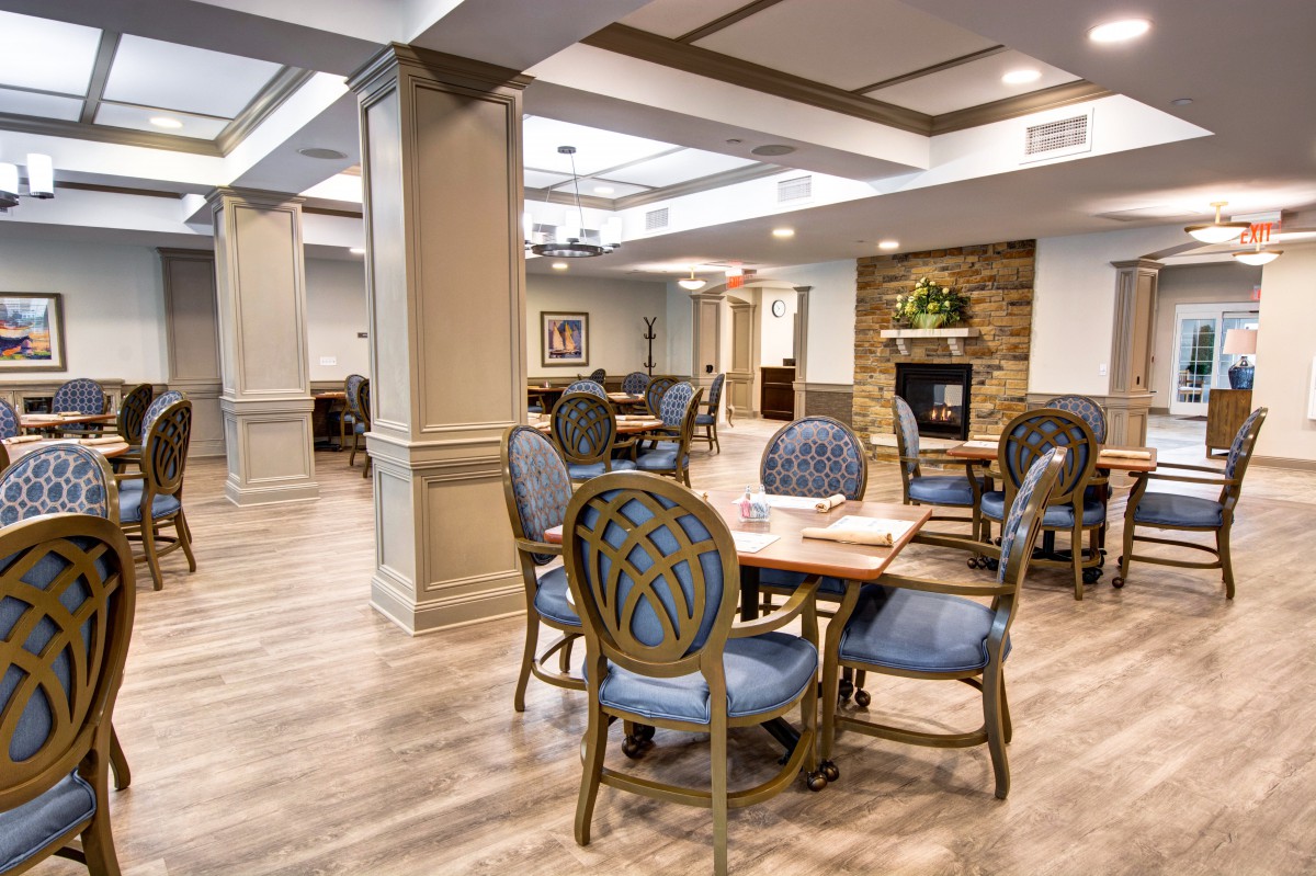 A well-appointed dining area with polished wood flooring and elegant furniture.