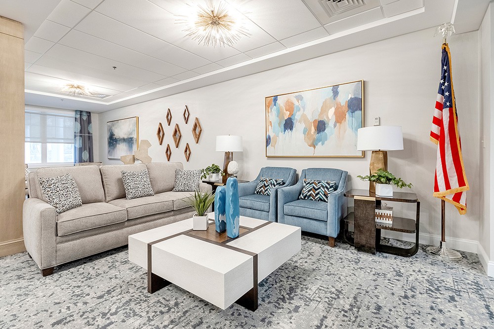 A modern living room with comfortable seating, stylish artwork, and elegant decor.