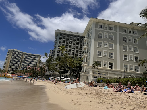 A sunny beach scene featuring hotels and a clear sky.