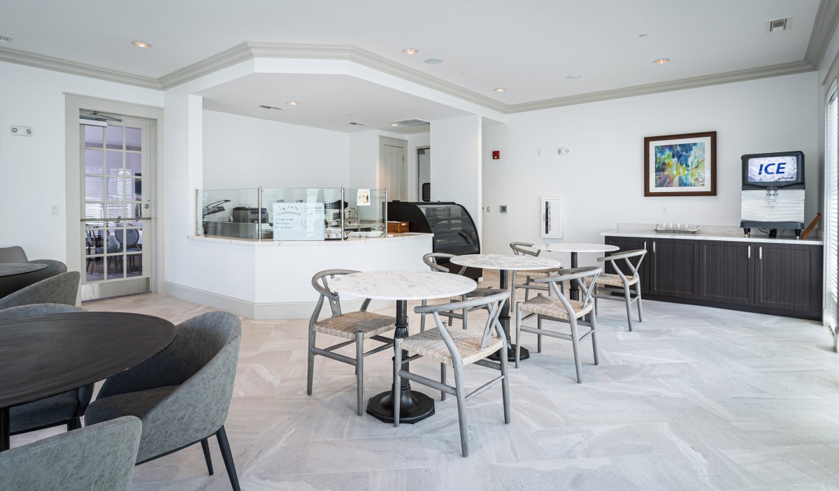 A modern, minimalist dining area with sleek furniture and bright lighting.