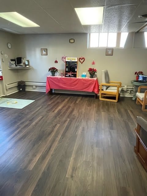 A cozy room with a decorated table and comfortable seating, featuring Valentine-themed decor.