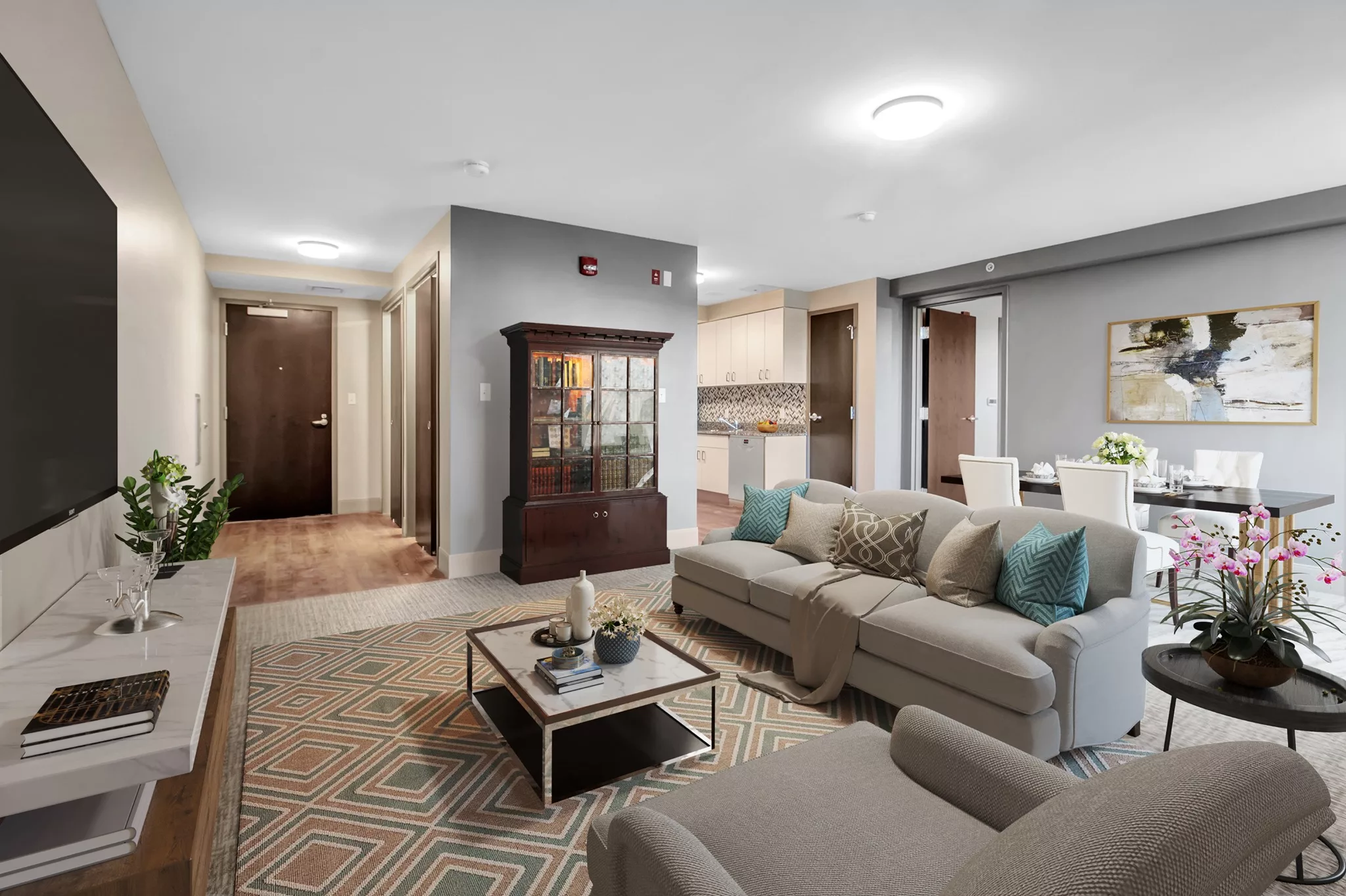 A modern living room with a comfortable sofa, coffee table, and an adjacent dining area.