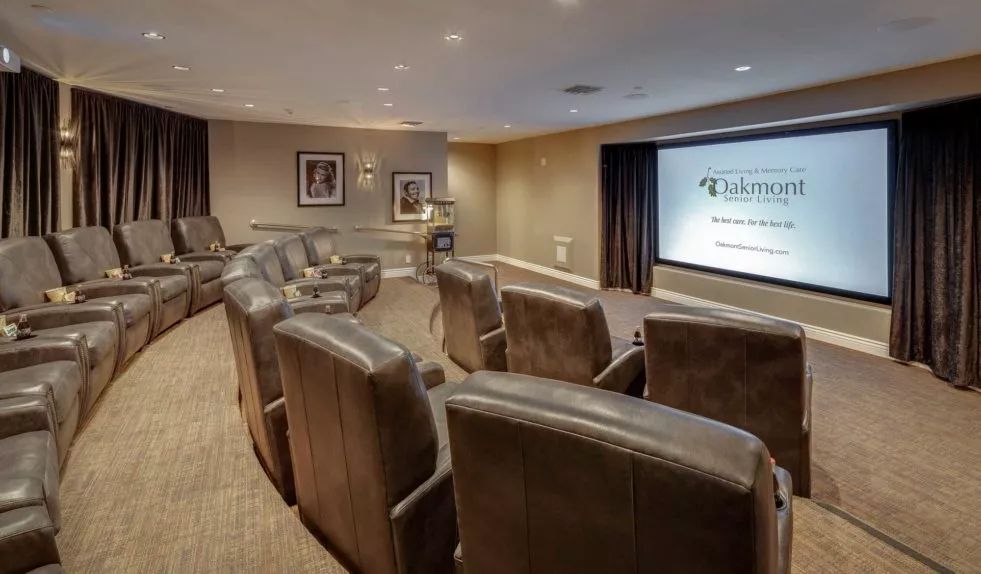 A luxurious home theater setup with comfortable seating and a large screen.